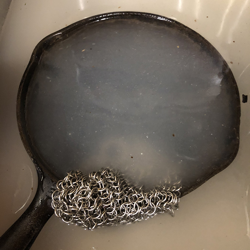 Pan in a sink of disgusting water